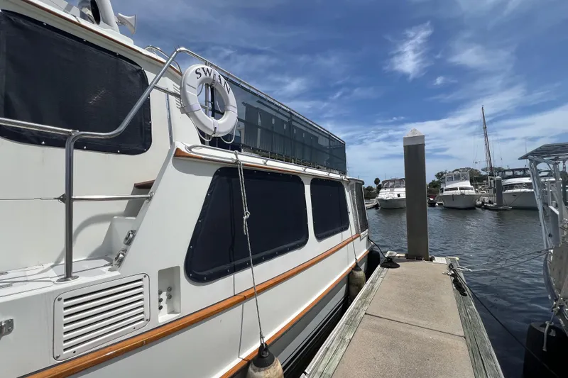 Slide: The Image of Interior of 1989 Hans Christian INDEPENDENCE 45 TRAWLER with glass storage and patterned rug. - 58