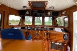 Slide: The Image of 1989 Hans Christian INDEPENDENCE 45 TRAWLER deck view at marina, showcasing sleek design. - 6