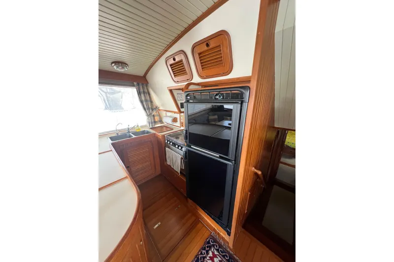 Slide: The Image of Interior of 1989 Hans Christian INDEPENDENCE 45 TRAWLER with blue plaid seating and wooden table. - 79