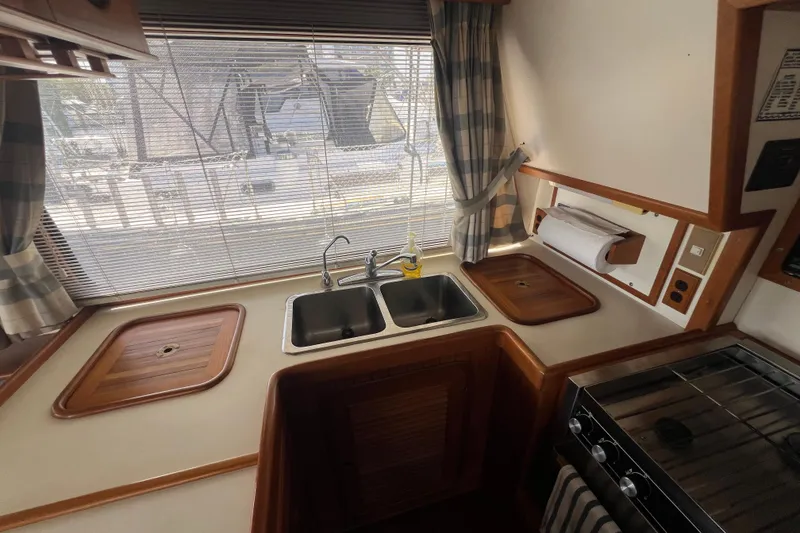 Slide: The Image of Interior of 1989 Hans Christian INDEPENDENCE 45 TRAWLER with rolled charts on ceiling rack. - 80