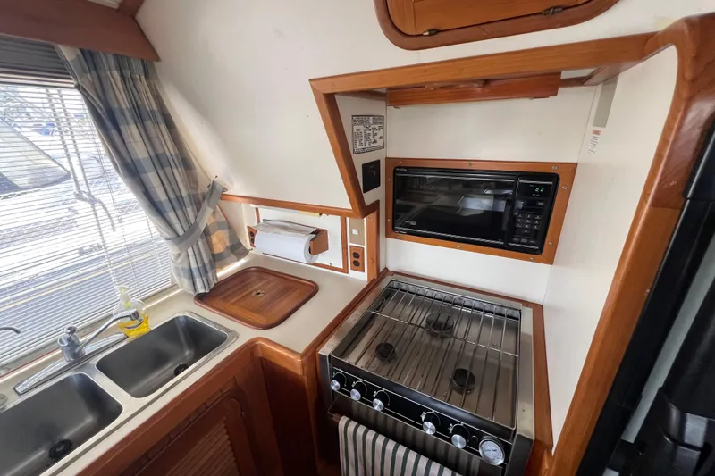 Slide: The Image of Compass on 1989 Hans Christian INDEPENDENCE 45 TRAWLER, wooden dashboard background. - 81