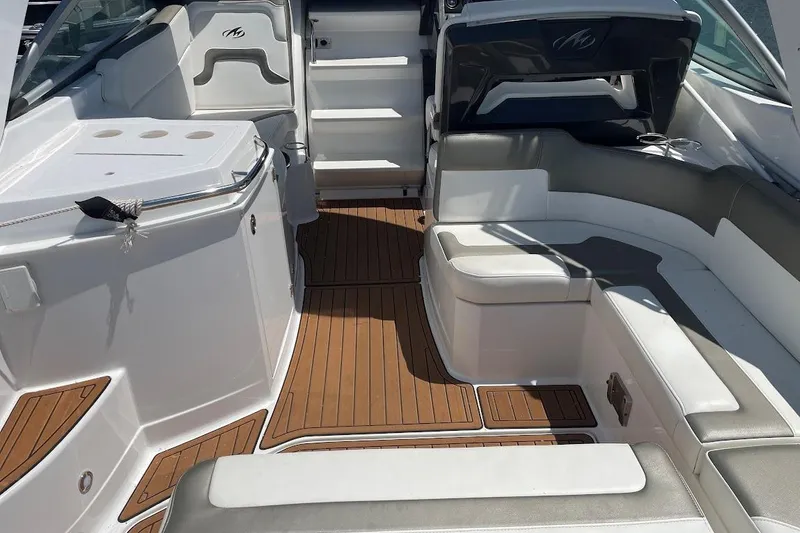 Slide: The Image of 2017 Monterey 275 Sport Yacht interior with sleek seating and wood-style flooring. - 21