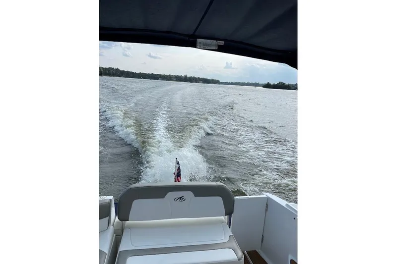 Slide: The Image of 2017 Monterey 275 Sport Yacht cruising on a lake, leaving a wake behind. - 13