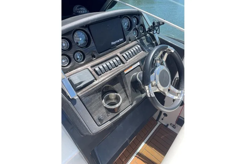 Slide: The Image of Steering console of 2017 Monterey 275 Sport Yacht with Raymarine display and gauges. - 18