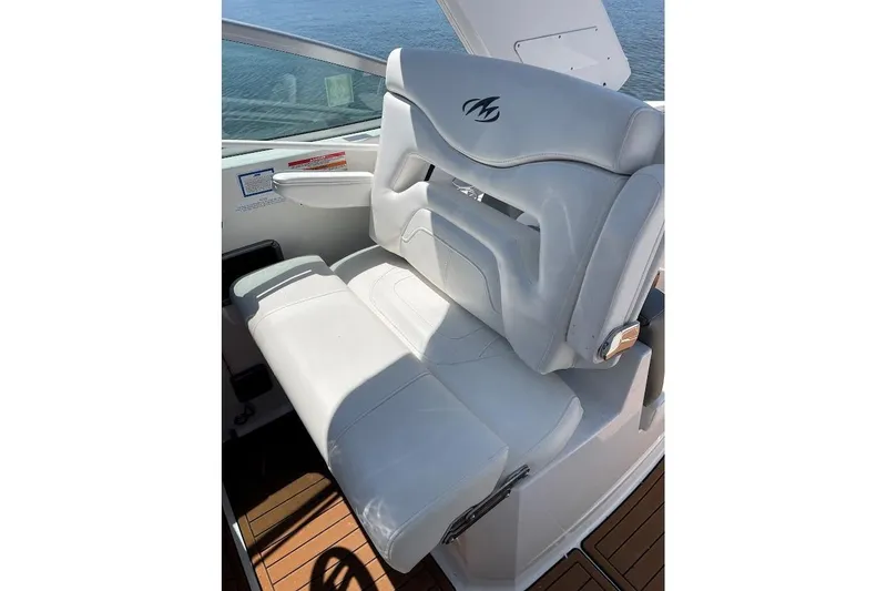 Slide: The Image of White leather seat on 2017 Monterey 275 Sport Yacht, overlooking water. - 19