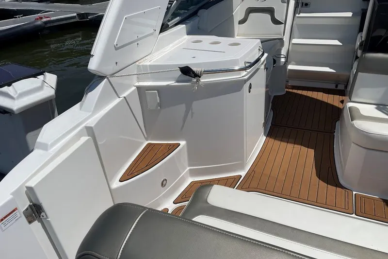 Slide: The Image of 2017 Monterey 275 Sport Yacht interior with teak flooring and seating area. - 20