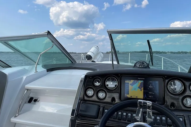 Slide: The Image of Cockpit view of 2017 Monterey 275 Sport Yacht with navigation system on open water. - 24