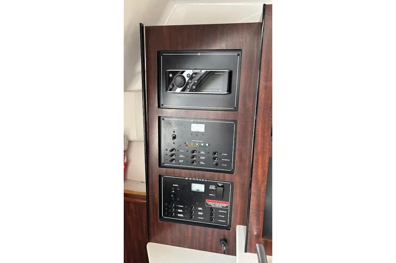 Slide: The Image of Control panel of a 2018 Monterey 275 Sport Yacht with audio and electrical systems. - 28