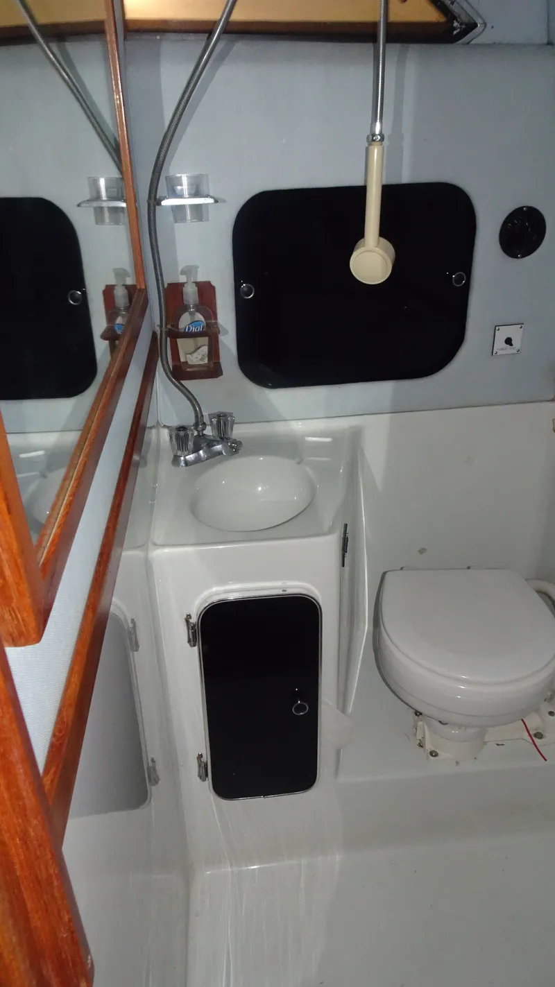 Slide: The Image of 1987 Sea Ray 340 Sundancer bathroom with sink and toilet. - 24