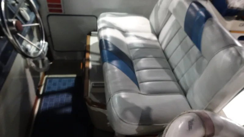 Slide: The Image of Interior of 1987 Sea Ray 340 Sundancer boat with steering wheel and bench seat. - 6