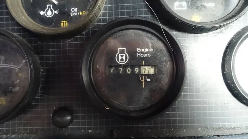 Slide: The Image of 1987 Sea Ray 340 Sundancer engine hours gauge, displaying 7097 hours. - 9