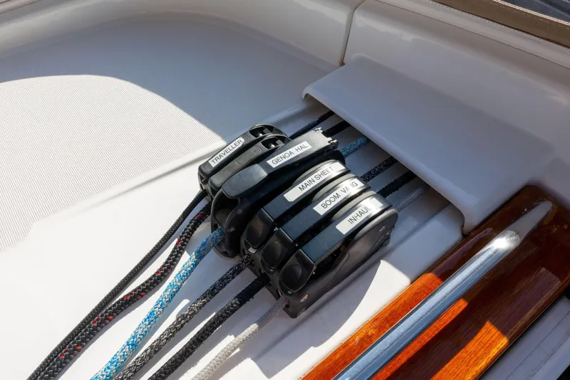 Slide: The Image of Jeanneau 53 yacht deck with winch and ropes, 2015 model, on calm water. - 20