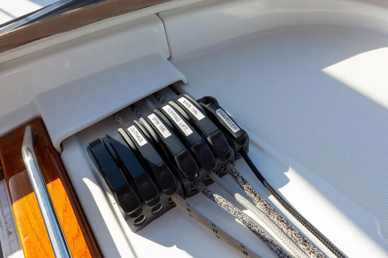 Slide: The Image of Rope clutches on a 2015 Jeanneau 53 sailboat deck, labeled for various sailing functions. - 21