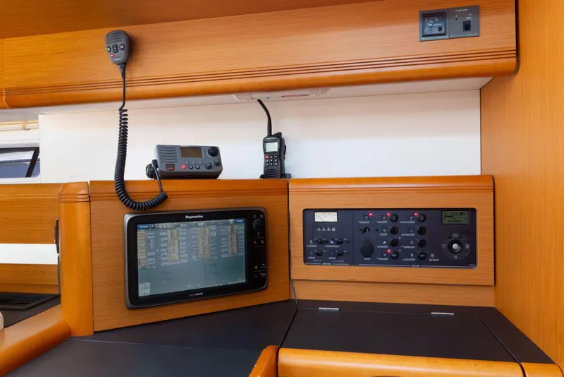 Slide: The Image of Interior of 2015 Jeanneau 53 yacht with navigation equipment and wooden finish. - 27