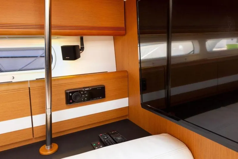 Slide: The Image of Luxurious interior of 2015 Jeanneau 53 yacht with white seating and decorative pillows. - 33