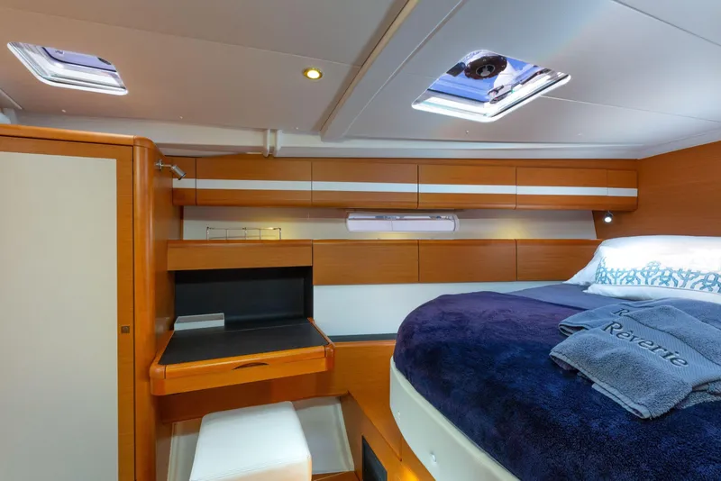 Slide: The Image of Luxurious cabin interior of a 2015 Jeanneau 53 yacht with cozy bedding. - 35