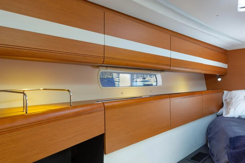 Slide: The Image of Interior of 2015 Jeanneau 53 yacht featuring wooden cabinetry and a fold-out desk. - 37