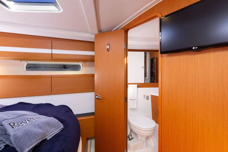 Slide: The Image of Luxurious interior of 2015 Jeanneau 53 yacht with elegant wood cabinetry and cozy bedding. - 38