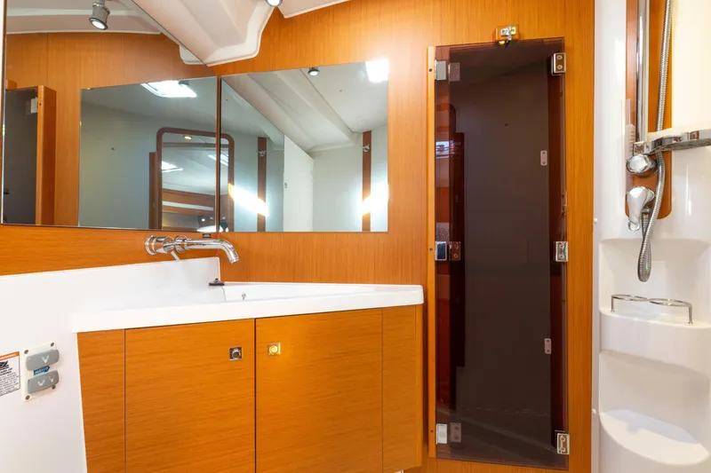 Slide: The Image of Luxurious bathroom interior of 2015 Jeanneau 53 yacht with modern fixtures and wood finish. - 40