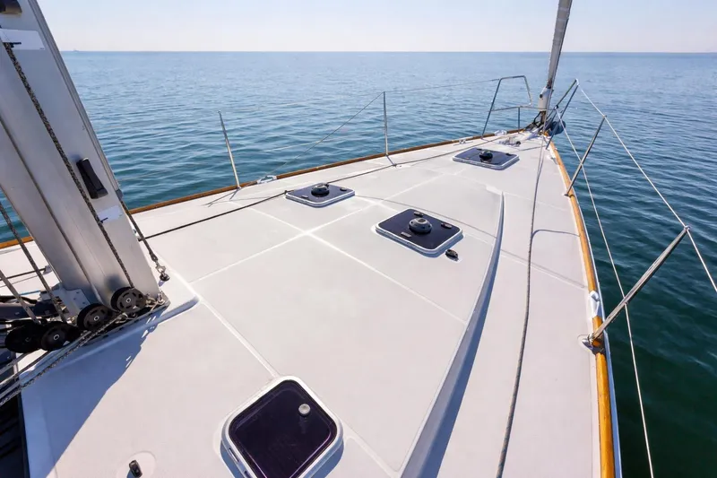 Slide: The Image of Deck view of a 2015 Jeanneau 53 sailboat on calm sea. - 6