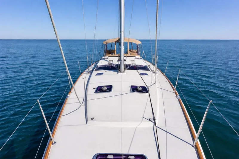 Slide: The Image of 2015 Jeanneau 53 yacht sailing on calm blue sea under clear sky. - 8