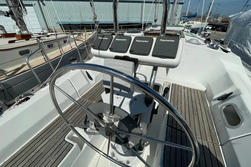 Slide: The Image of Cockpit of 1988 Beneteau Oceanis 350 sailboat with steering wheel and Raymarine instruments. - 10