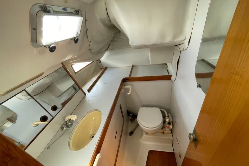 Slide: The Image of Bathroom interior of 1988 Beneteau Oceanis 350 sailboat, featuring sink and toilet. - 19