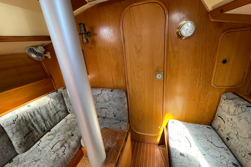 Slide: The Image of Interior of 1988 Beneteau Oceanis 350 sailboat with wood paneling and patterned seating. - 20