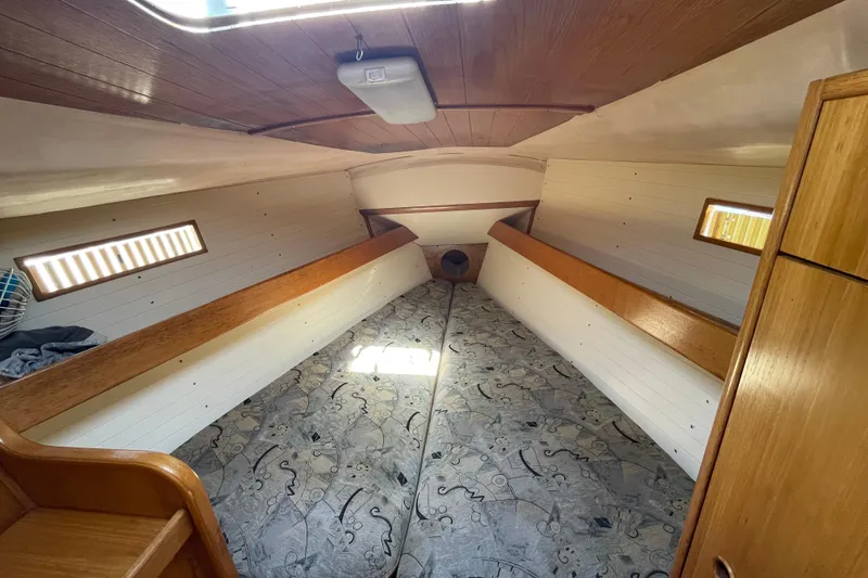 Slide: The Image of Interior cabin of 1988 Beneteau Oceanis 350 sailboat, featuring cozy sleeping quarters. - 21