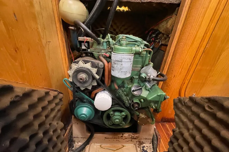 Slide: The Image of Engine compartment of a 1988 Beneteau Oceanis 350 sailboat, showcasing detailed mechanical components. - 24