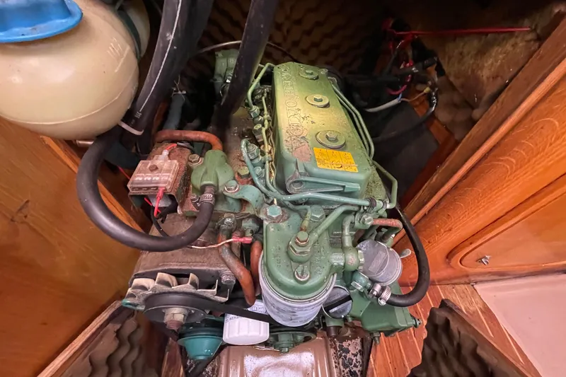 Slide: The Image of Engine compartment of a 1988 Beneteau Oceanis 350 sailboat, featuring a Volvo Penta engine. - 25