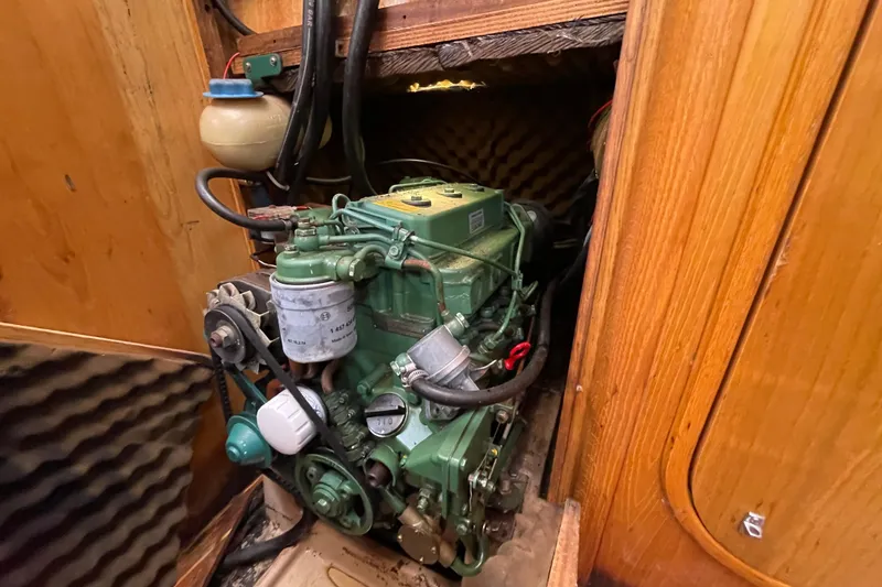 Slide: The Image of Engine compartment of a 1988 Beneteau Oceanis 350 sailboat, showcasing detailed mechanical components. - 26