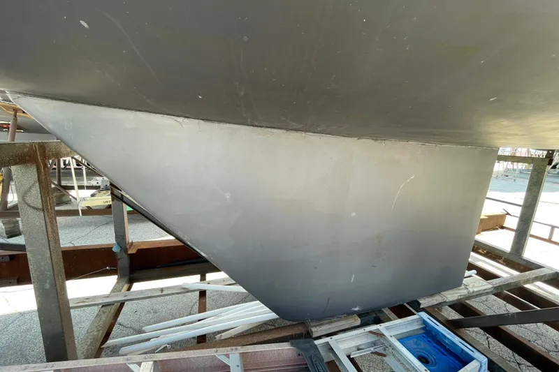 Slide: The Image of 1988 Beneteau Oceanis 350 keel on dry dock, showcasing sleek design and structure. - 6