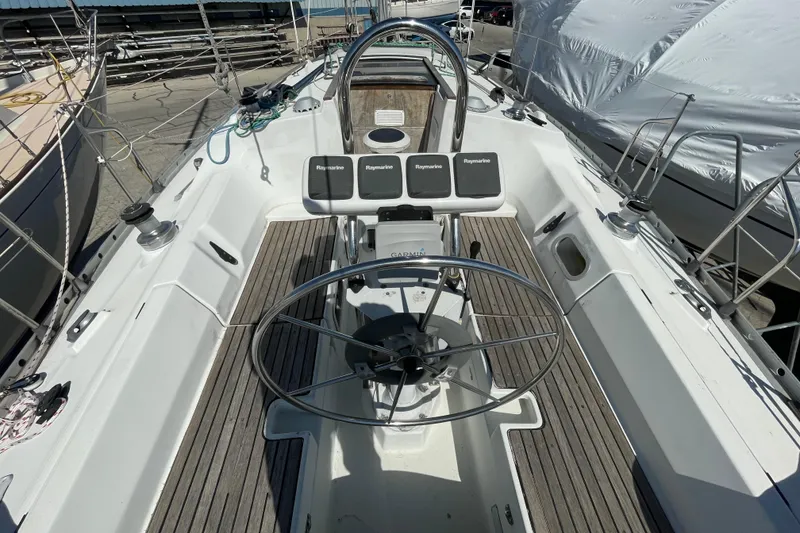 Slide: The Image of Cockpit of 1988 Beneteau Oceanis 350 sailboat with steering wheel and navigation instruments. - 8