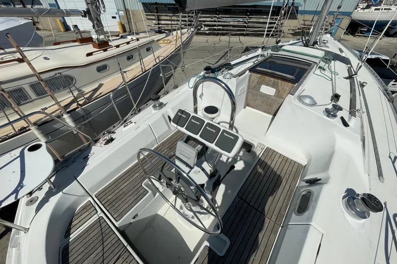 Slide: The Image of Cockpit of 1988 Beneteau Oceanis 350 sailboat with steering wheel and navigation instruments. - 9