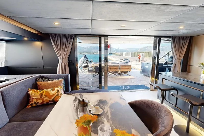 Slide: The Image of Luxurious interior of 2024 Sunreef 60 Sail Eco yacht with elegant dining area and sea view. - 2