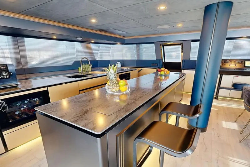 Slide: The Image of Luxurious interior of 2024 Sunreef 60 Sail Eco yacht with modern kitchen and seating. - 5