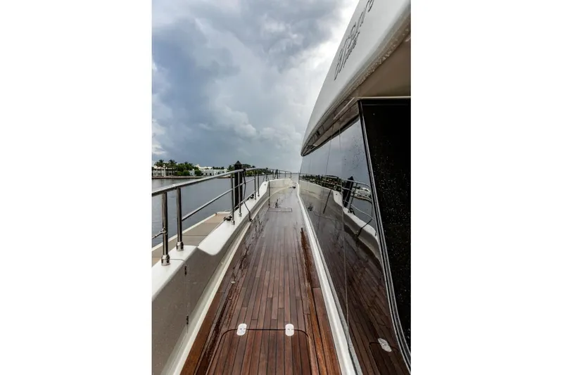 Slide: The Image of Luxurious Sunreef 80 Power yacht deck, 2024 model, with sleek design and wooden flooring. - 16