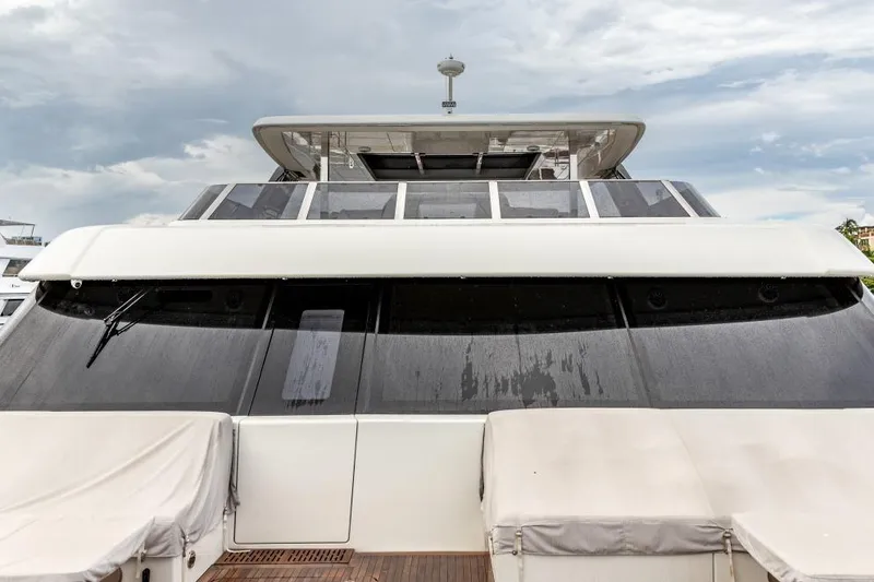 Slide: The Image of 2024 Sunreef 80 Power yacht, sleek design with large windows and covered seating area. - 17