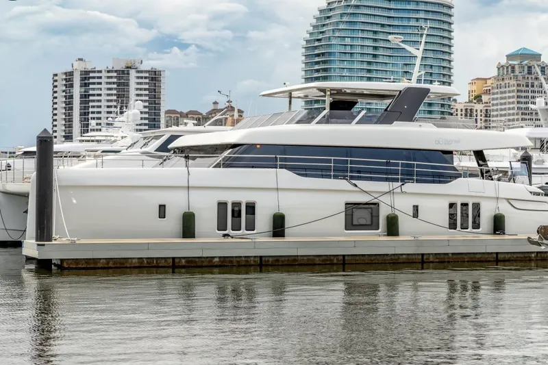 Slide: The Image of 2024 Sunreef 80 Power yacht docked at marina with cityscape background. - 18