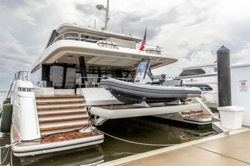Slide: The Image of 2024 Sunreef 80 Power yacht docked with tender boat on platform. - 19