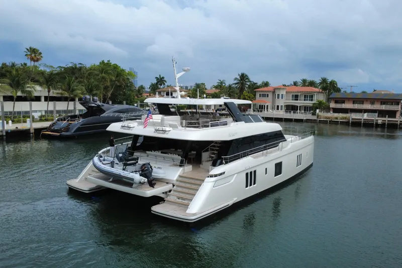 Slide: The Image of 2024 Sunreef 80 Power yacht docked in a scenic waterfront setting. - 21