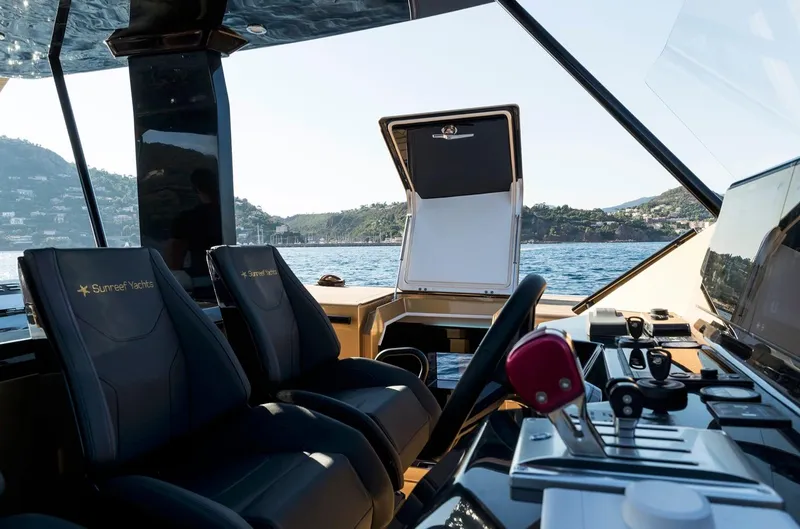 Slide: The Image of Interior view of 2018 Sunreef 40 Power yacht cockpit with scenic ocean backdrop. - 10