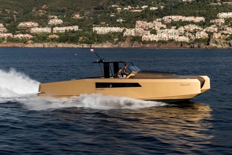 Slide: The Image of 2018 Sunreef 40 Power yacht cruising on a scenic coastal waterway. - 4