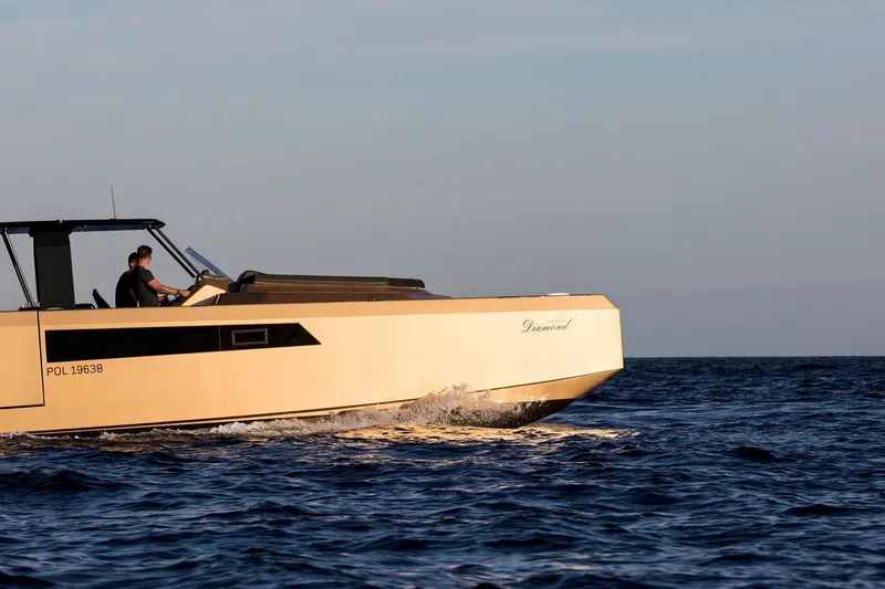 Slide: The Image of 2018 Sunreef 40 Power yacht cruising on open water at sunset. - 7