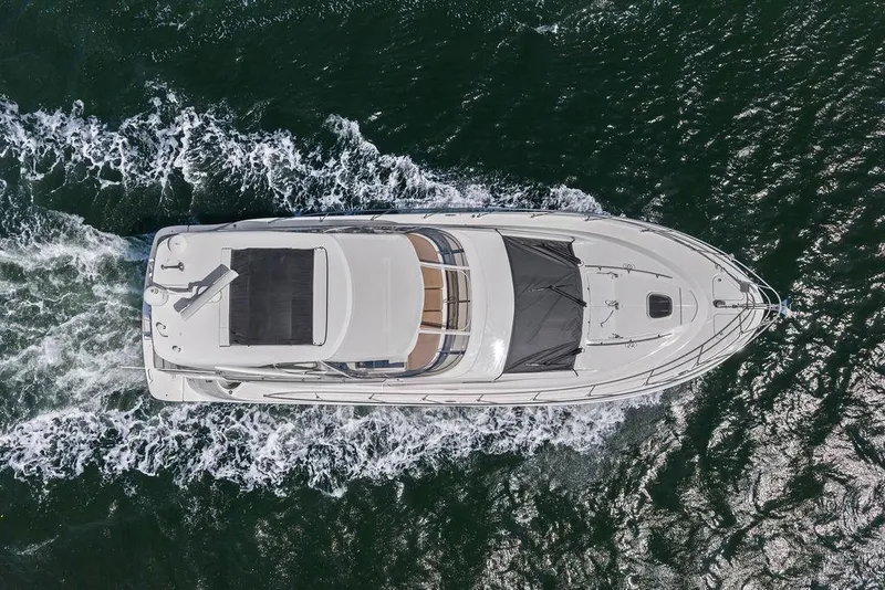 Slide: The Image of Aerial view of 2017 Sea Ray Fly 510 yacht cruising on open water. - 15