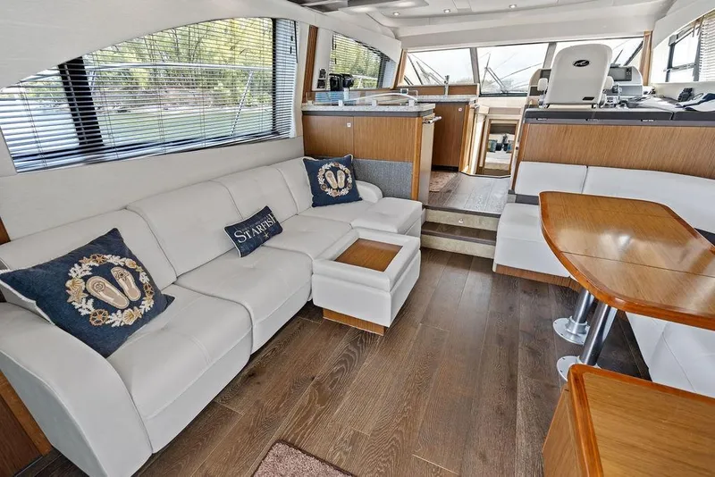 Slide: The Image of Luxurious interior of 2017 Sea Ray Fly 510 yacht with white leather seating and wooden accents. - 18