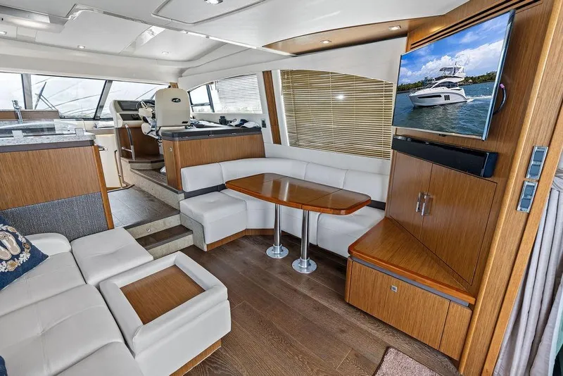 Slide: The Image of Luxurious interior of 2017 Sea Ray Fly 510 yacht with modern seating and entertainment area. - 19