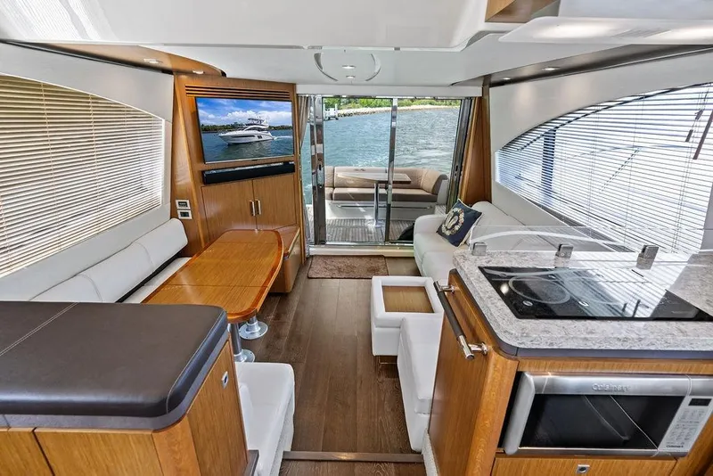 Slide: The Image of Luxurious interior of 2017 Sea Ray Fly 510 yacht with modern kitchen and seating area. - 21