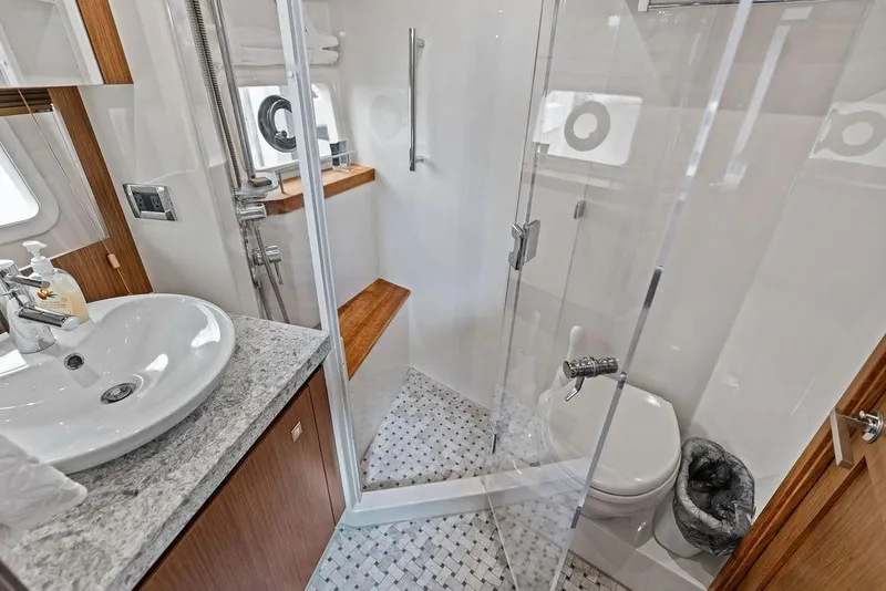 Slide: The Image of Luxurious bathroom on 2017 Sea Ray Fly 510 yacht with modern fixtures and glass shower. - 27